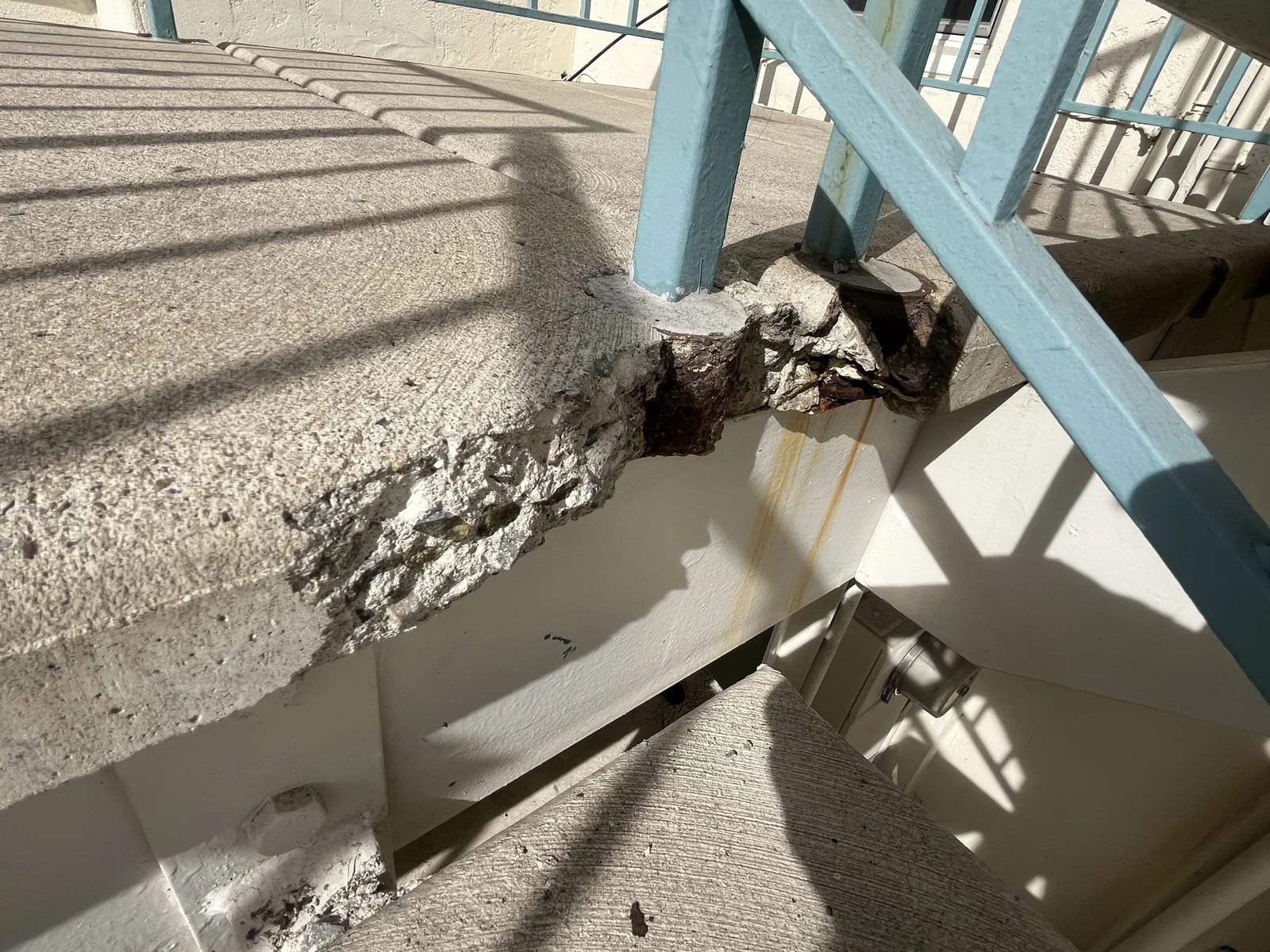 Damaged concrete edge at an exterior stair landing